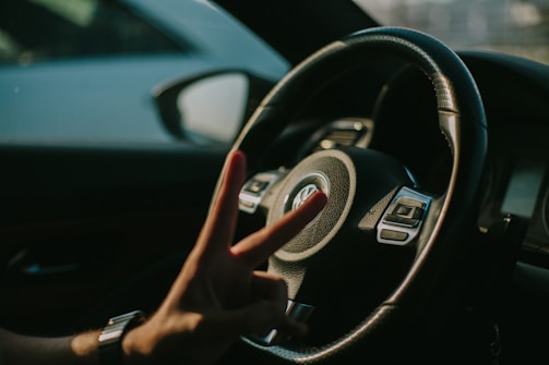 Close-up of hands shaking in agreement with a Volkswagen brochure on the table.