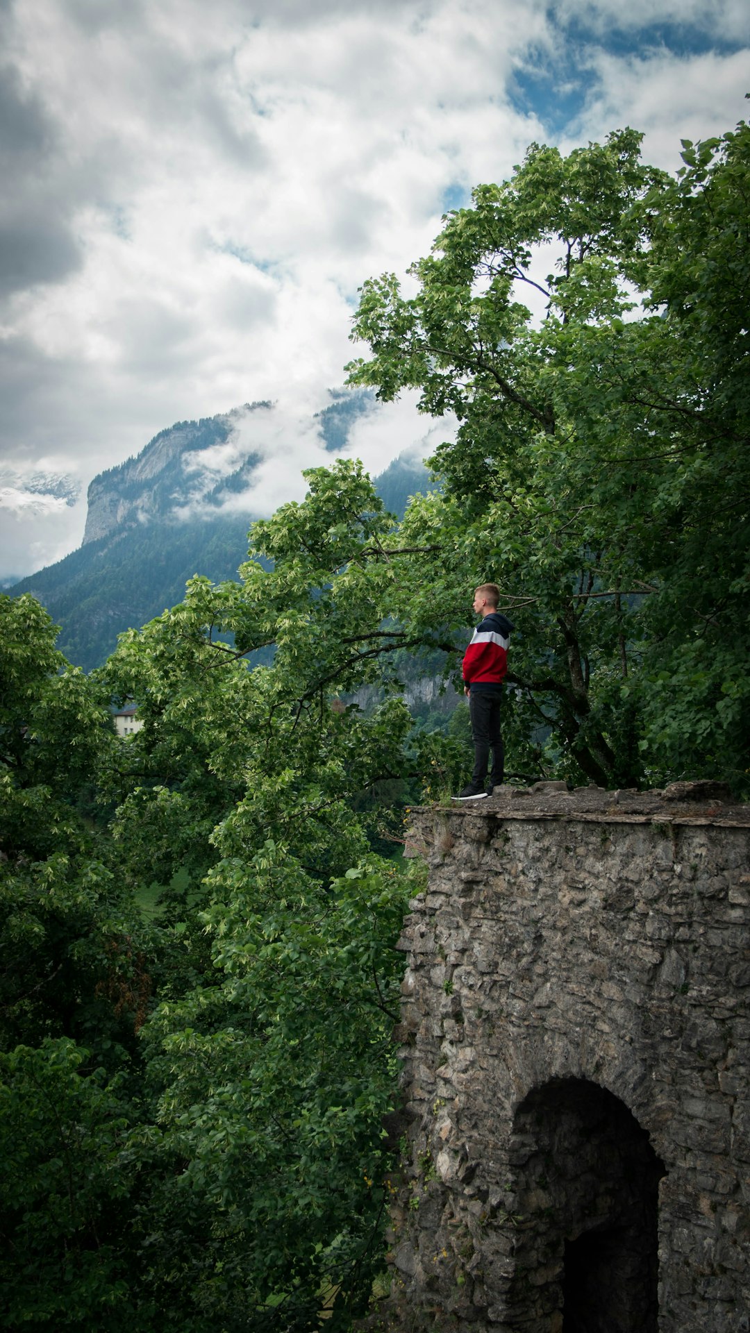 man standing on top of brick building