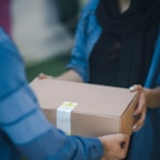 person giving brown box