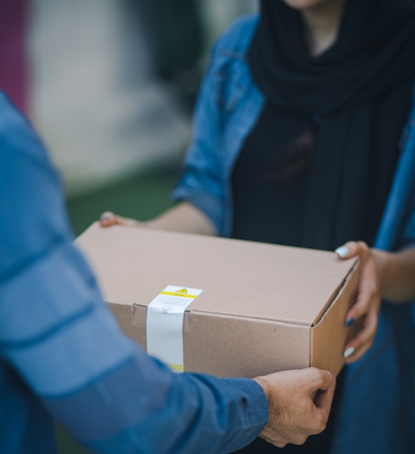 person giving brown box