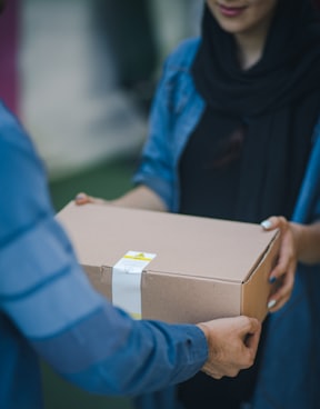 person giving brown box