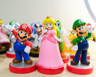 Mario, Luigi, and Princess Peach figurines