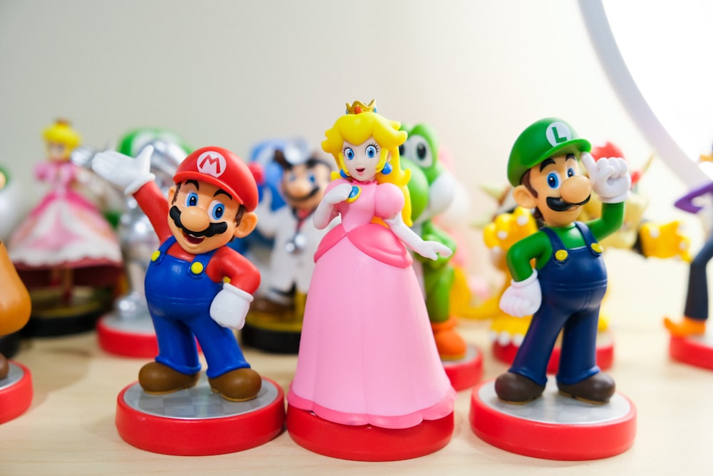 Mario, Luigi, and Princess Peach figurines