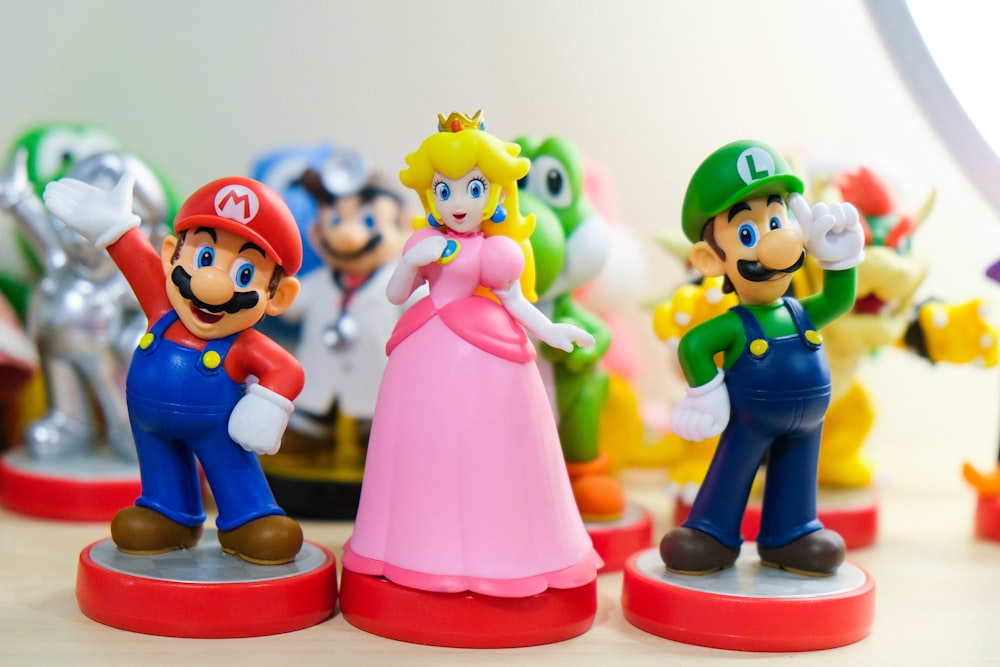 Super Mario, Luigi, and Princess Peach figurines