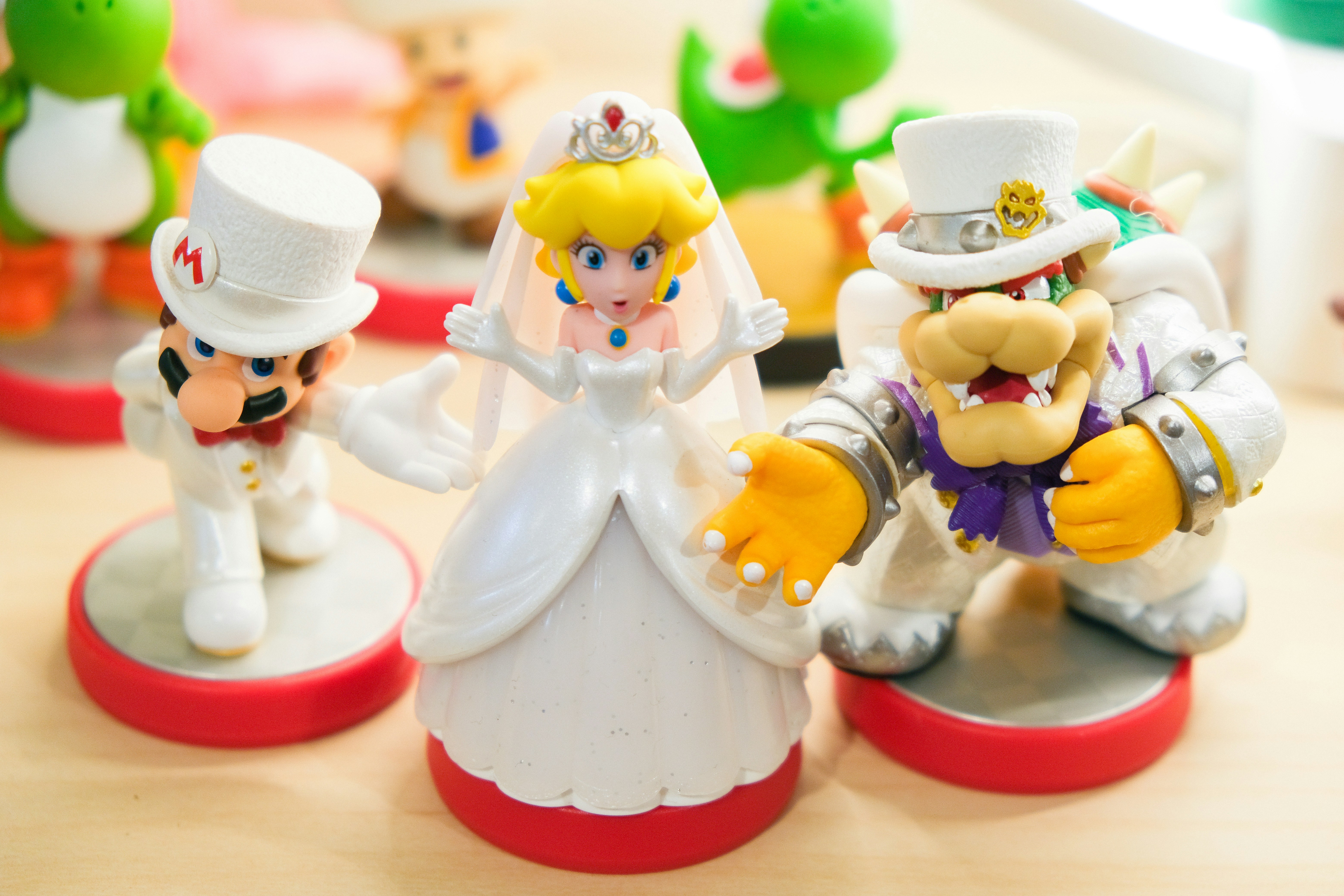 Nintendo amiibo toys of characters of Wedding Mario, Wedding Princess Peach, and Wedding Bowser proposing marriage focusing on Mario and Bowser
