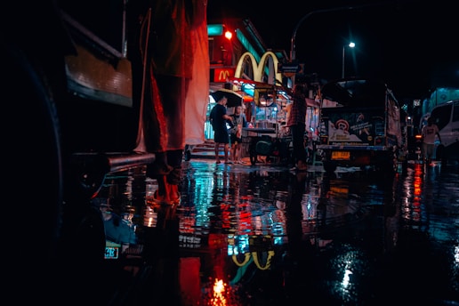 people near road and cars