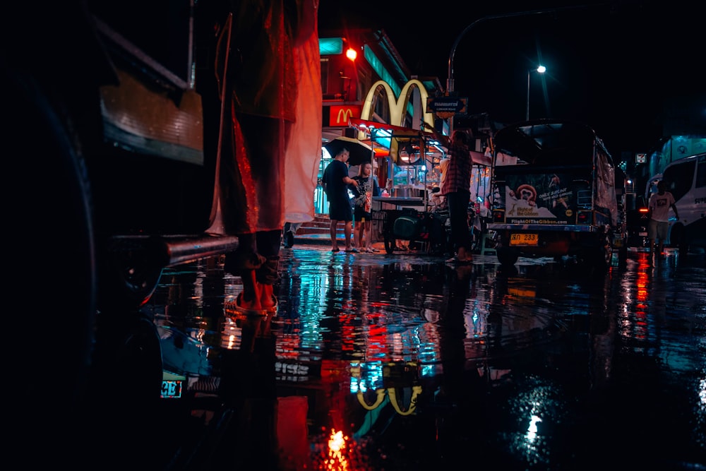 people near road and cars