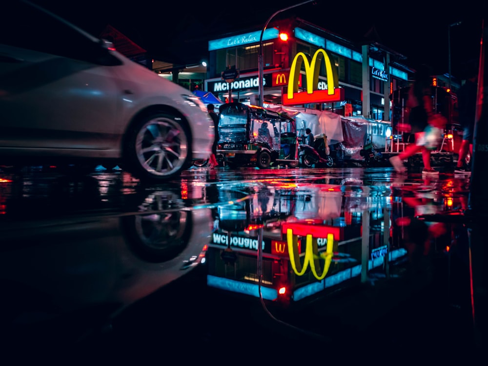 a reflection of a mcdonald's restaurant in a puddle