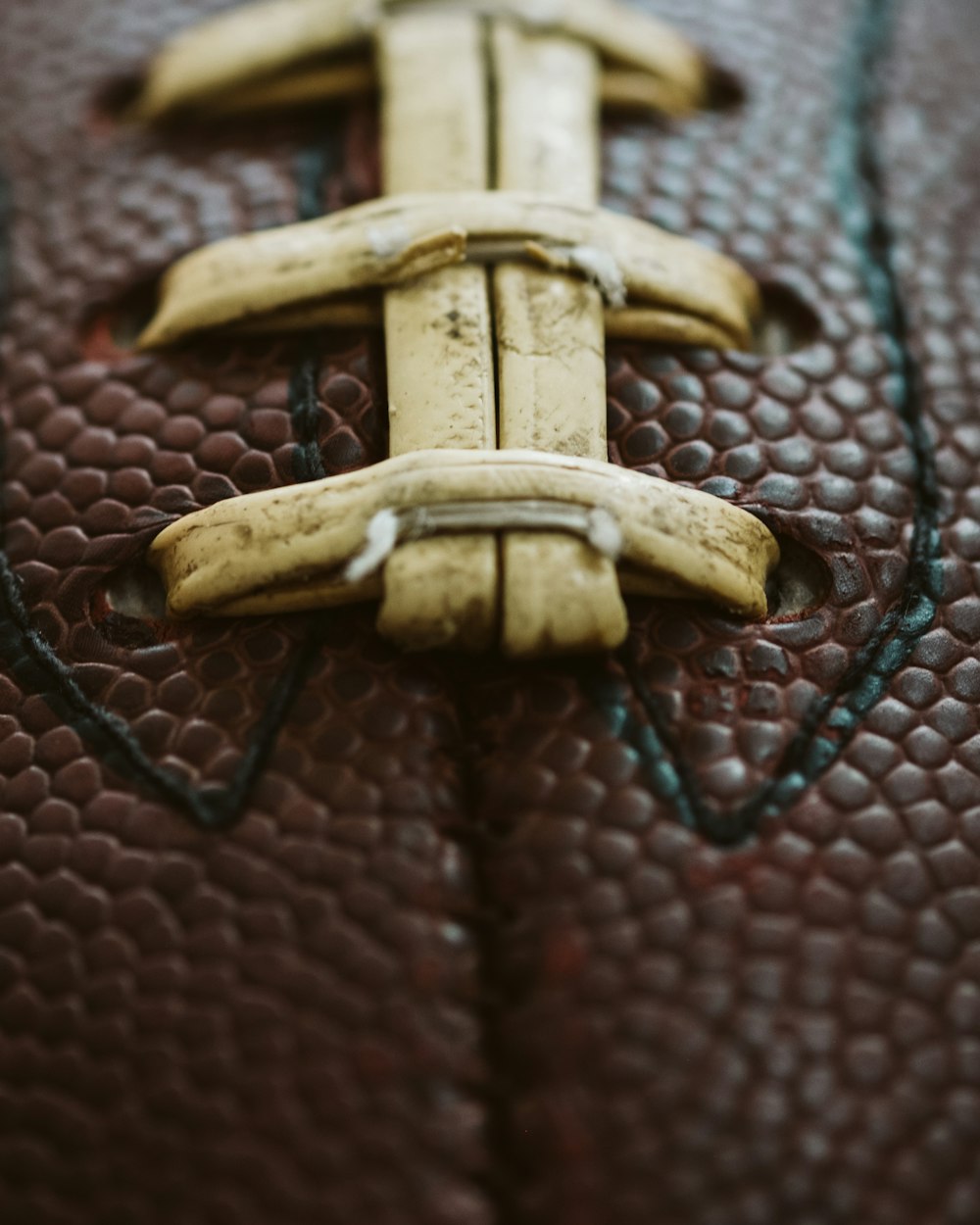 a close up of a leather object with a banana on it