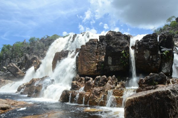 A waterfall pouring over dark rock — Chapada dos Veadeiros, Brazil