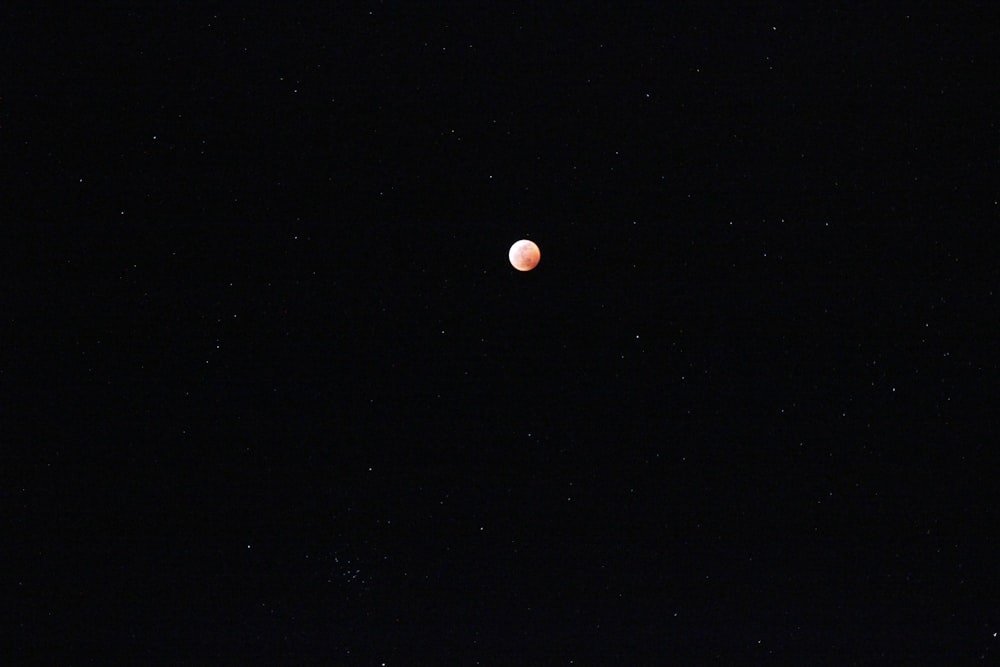 the moon is visible in the dark sky