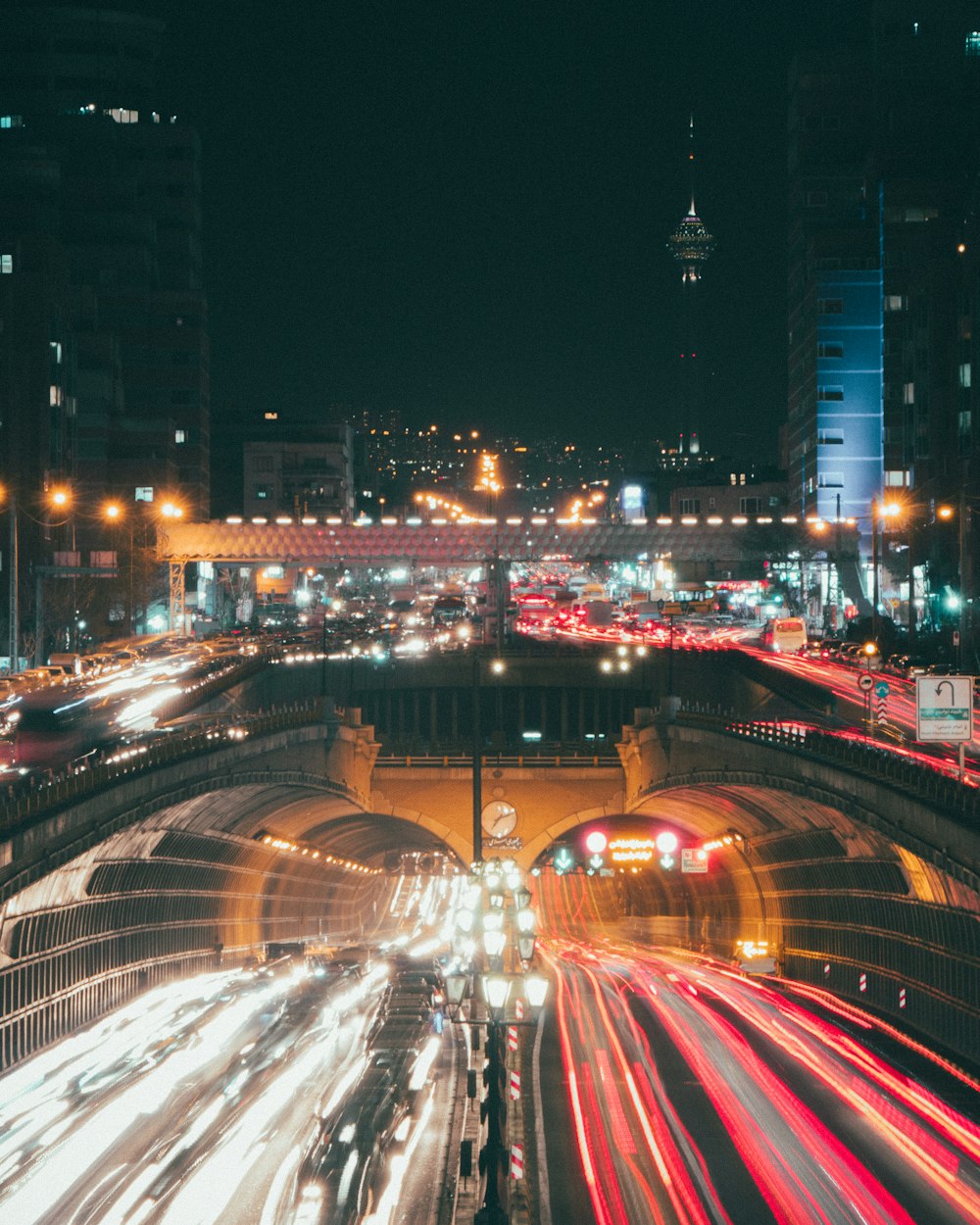 a city street filled with lots of traffic at night