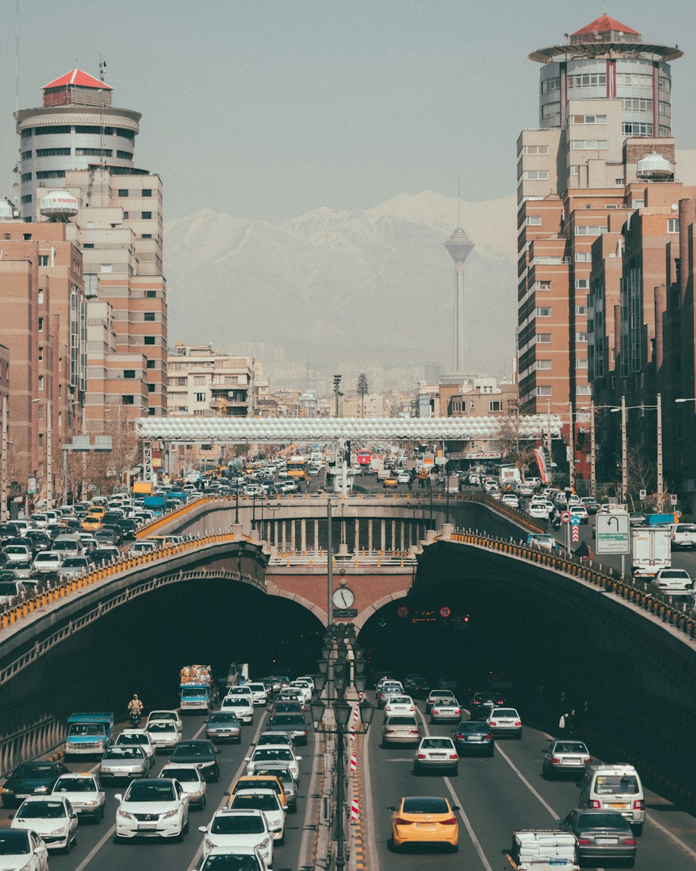 cars on road surrounded by buildings