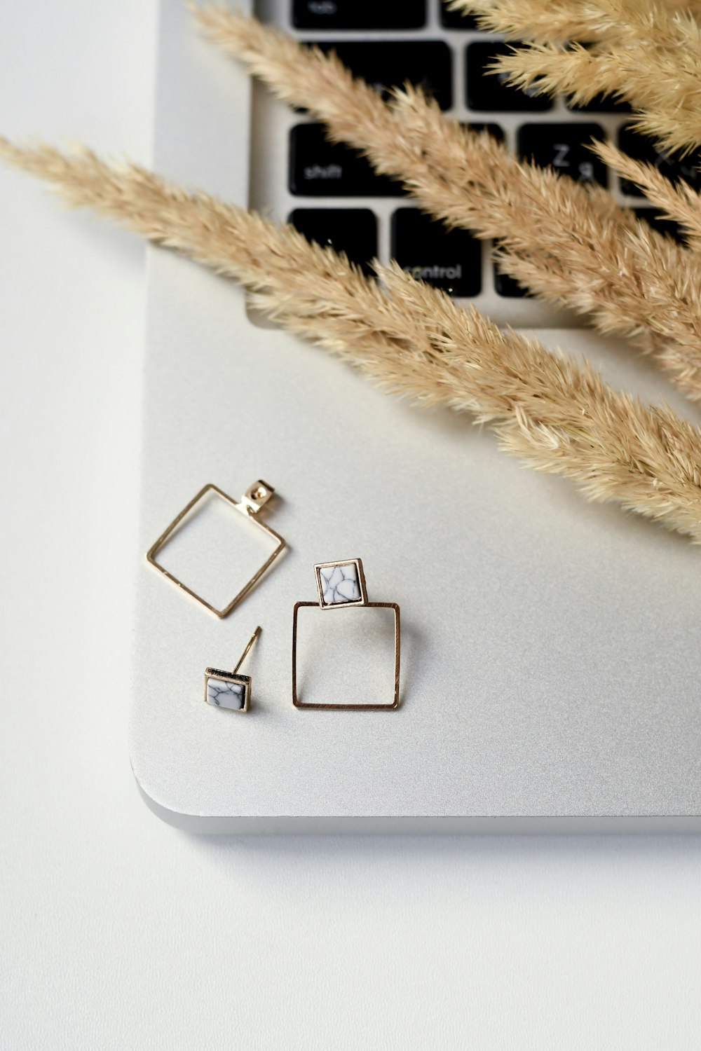gold earrings on MacBook