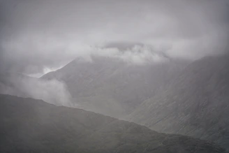 A minimalist mountain scene with misty layers, evoking calm and contemplation.