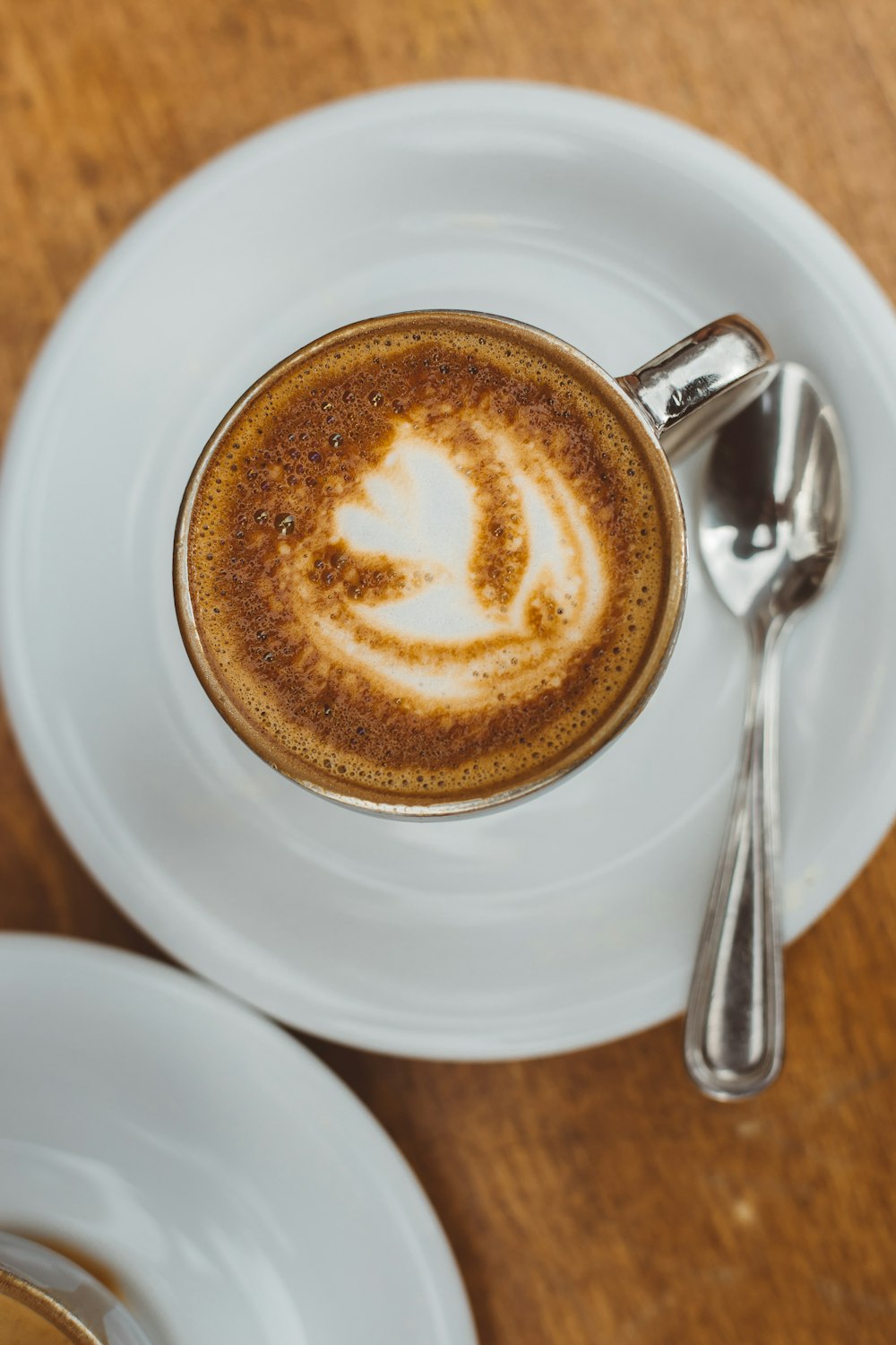 filled white teacup on saucer