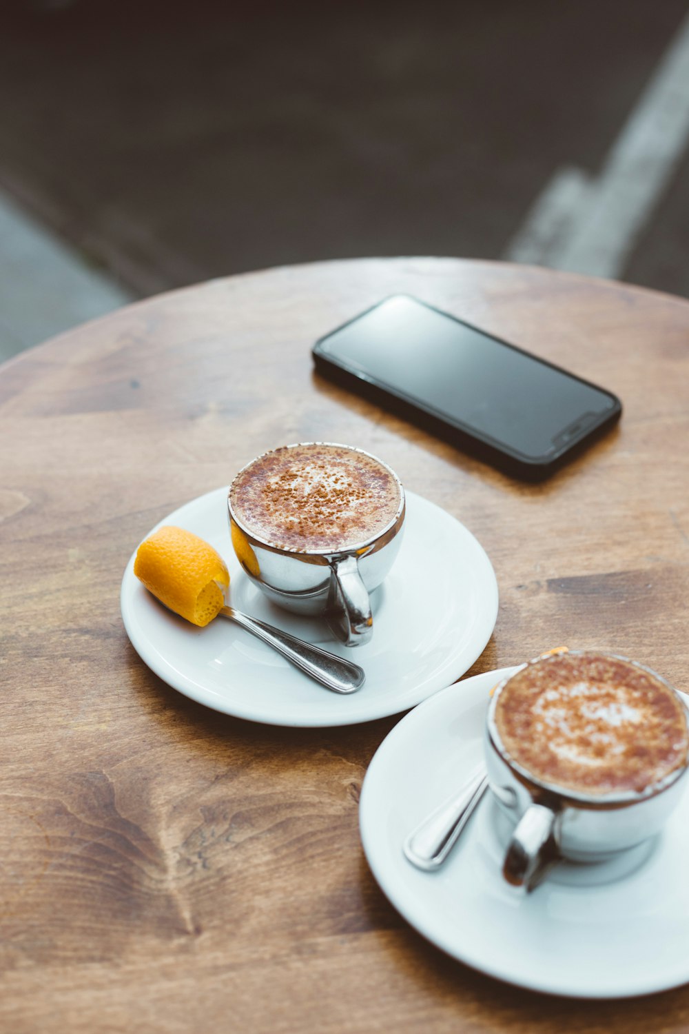 two filled cups on saucer