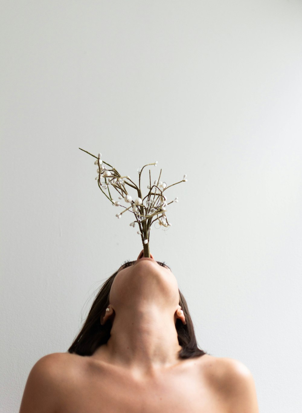 a woman with a plant on her head