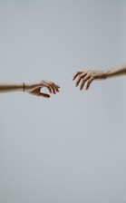 two hands about to hold wallpaper