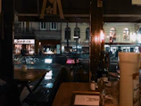 A rainy Seattle street scene viewed through a fogged café window with amber lights glowing warmly inside.