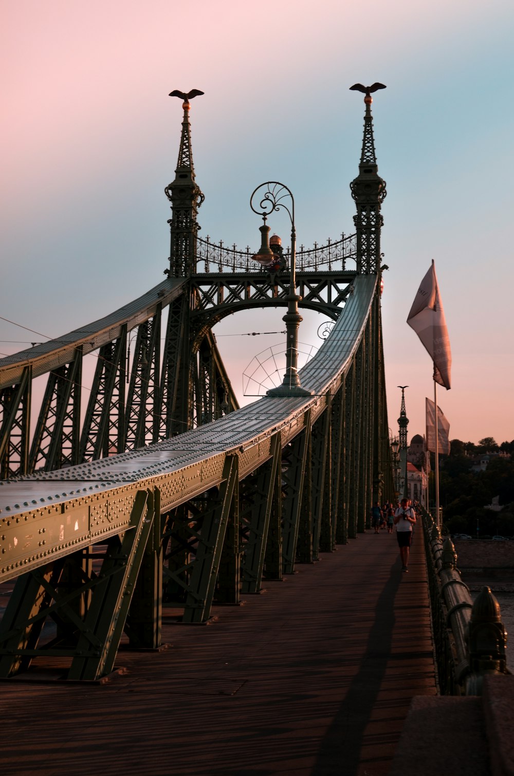 man walking on metal bridge