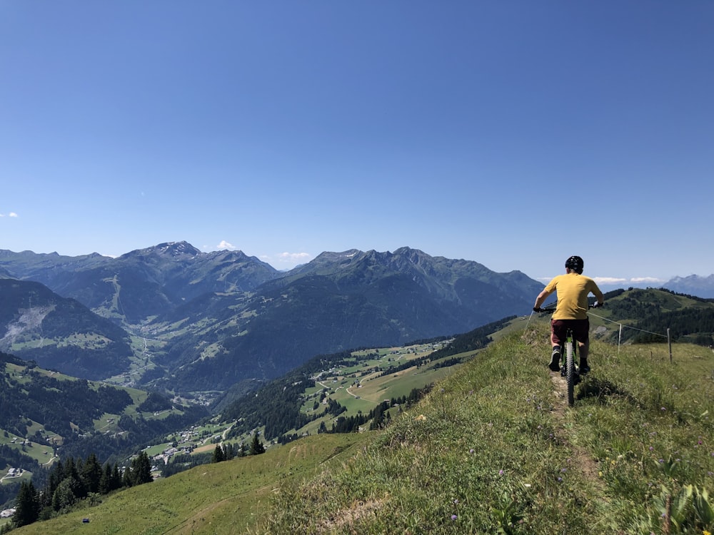 man rides bike on mountain