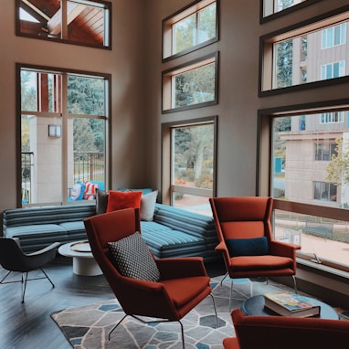 two orange sofa chairs inside room