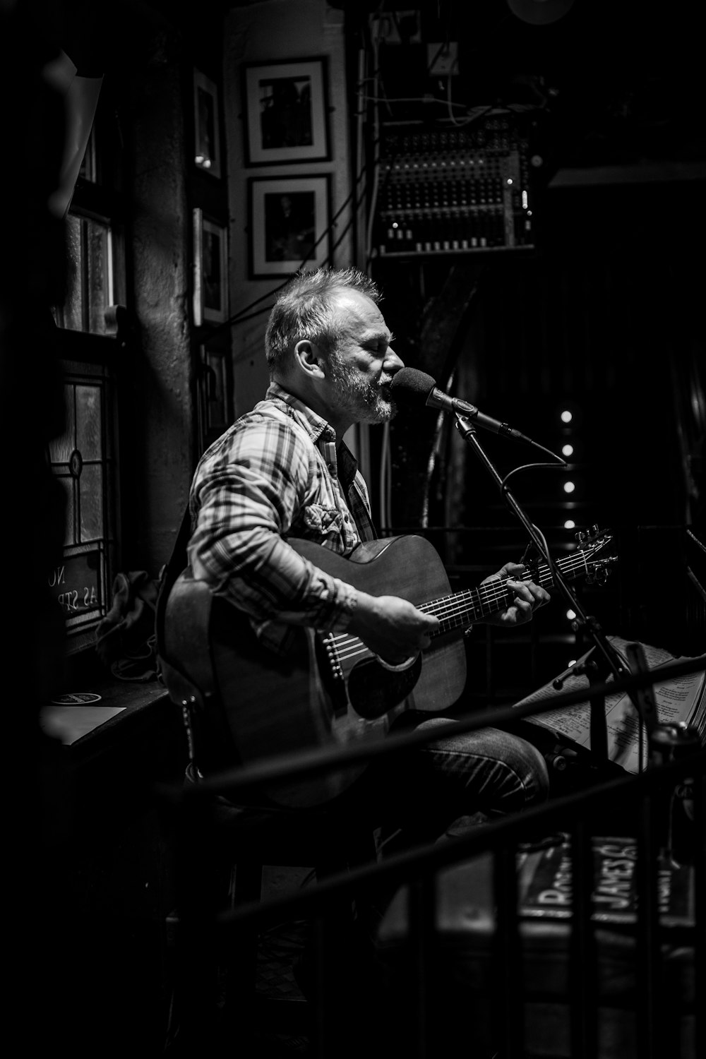 man playing guitar while singing