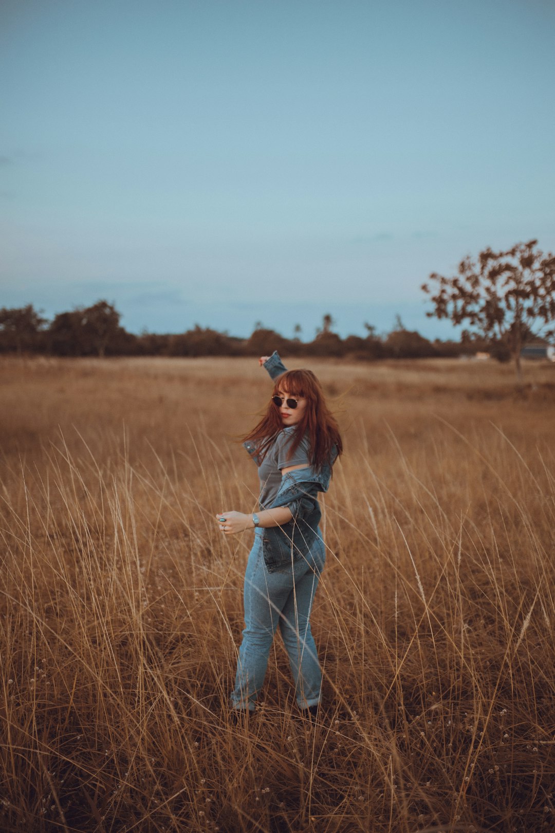 woman standing on the grass field