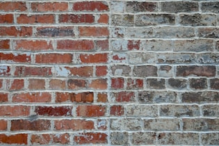 graffiti on brown and gray brick wall