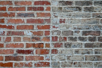graffiti on brown and gray brick wall