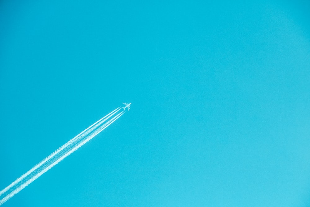 airplane on mid air under clear sky