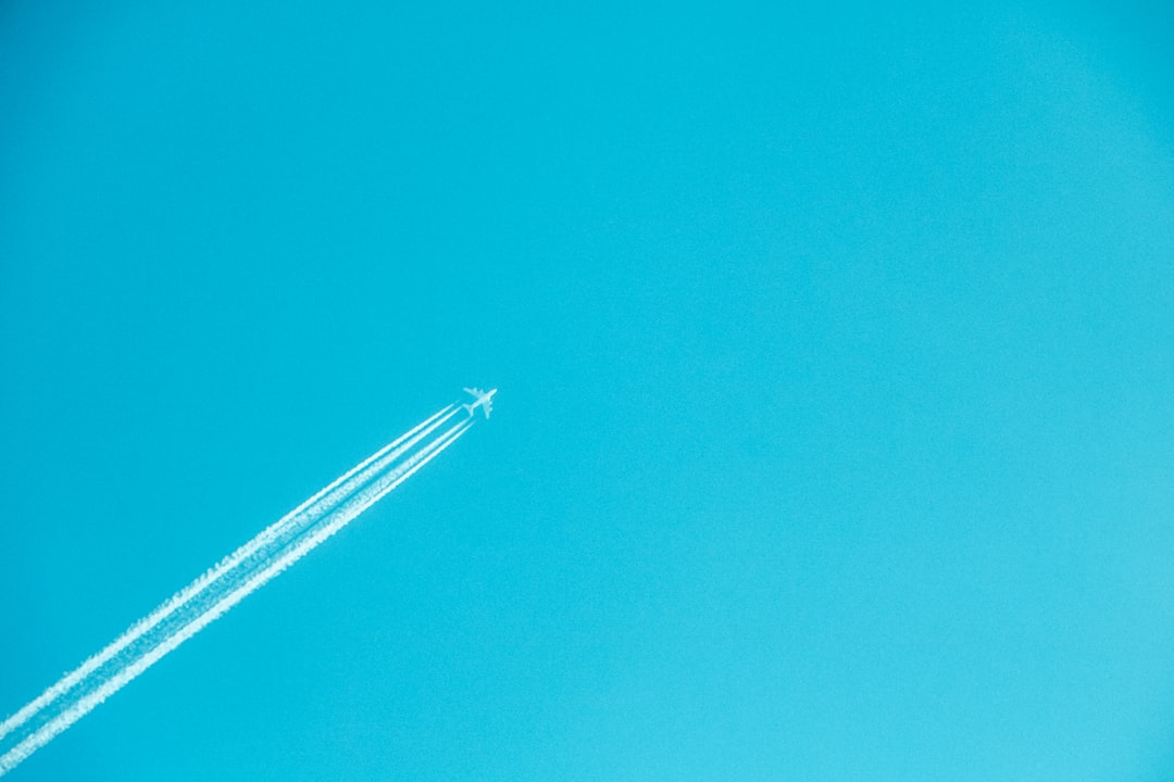airplane on mid air under clear sky,