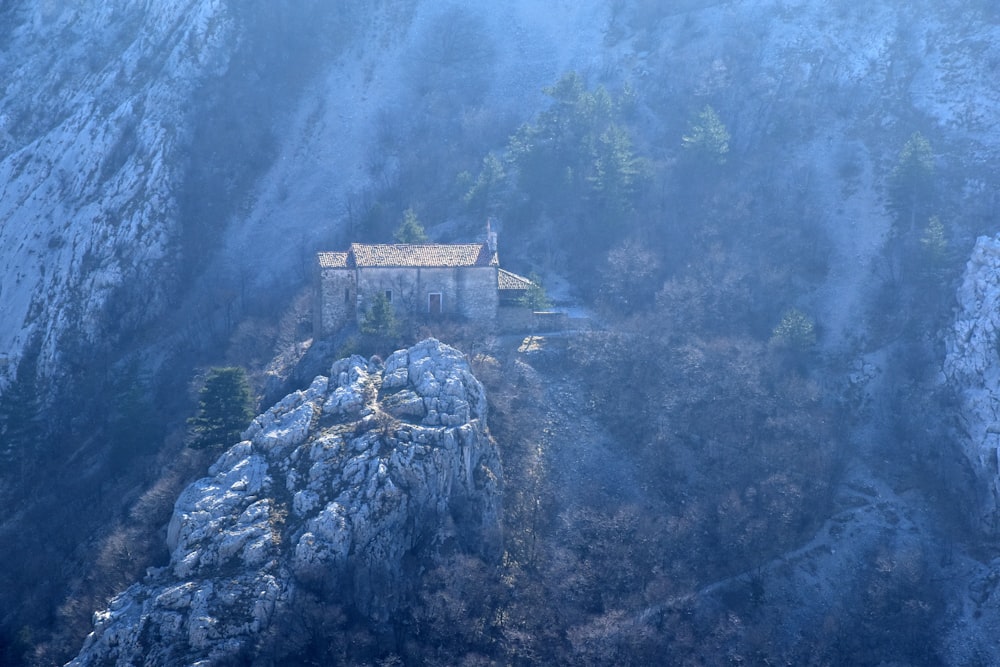 aerial photo of castle at middle of mountain