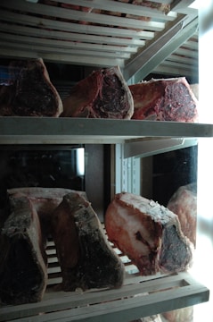 High-quality meat products packaged and displayed in a refrigerated warehouse.