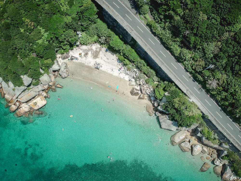 aerial photography of road beside body of water during daytime