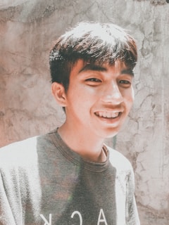 A warm, sunlit photo of a young adult smiling confidently, symbolizing hope and growth inspired by the Katie B Organization.