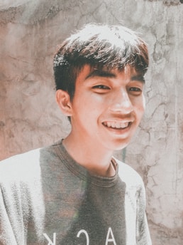 A warm, sunlit photo of a young adult smiling confidently, symbolizing hope and growth inspired by the Katie B Organization.