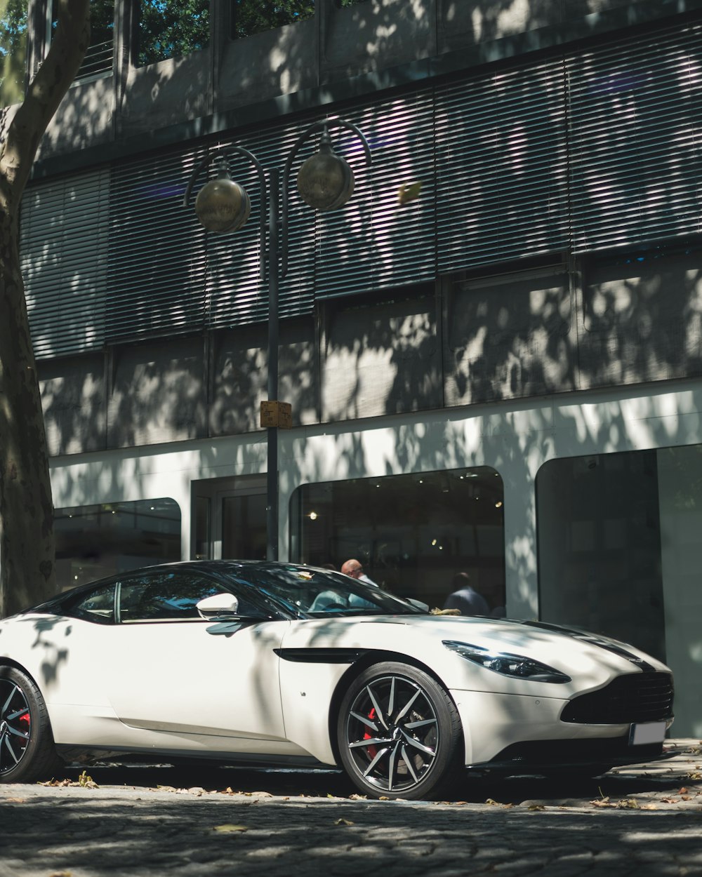 white coupe beside building