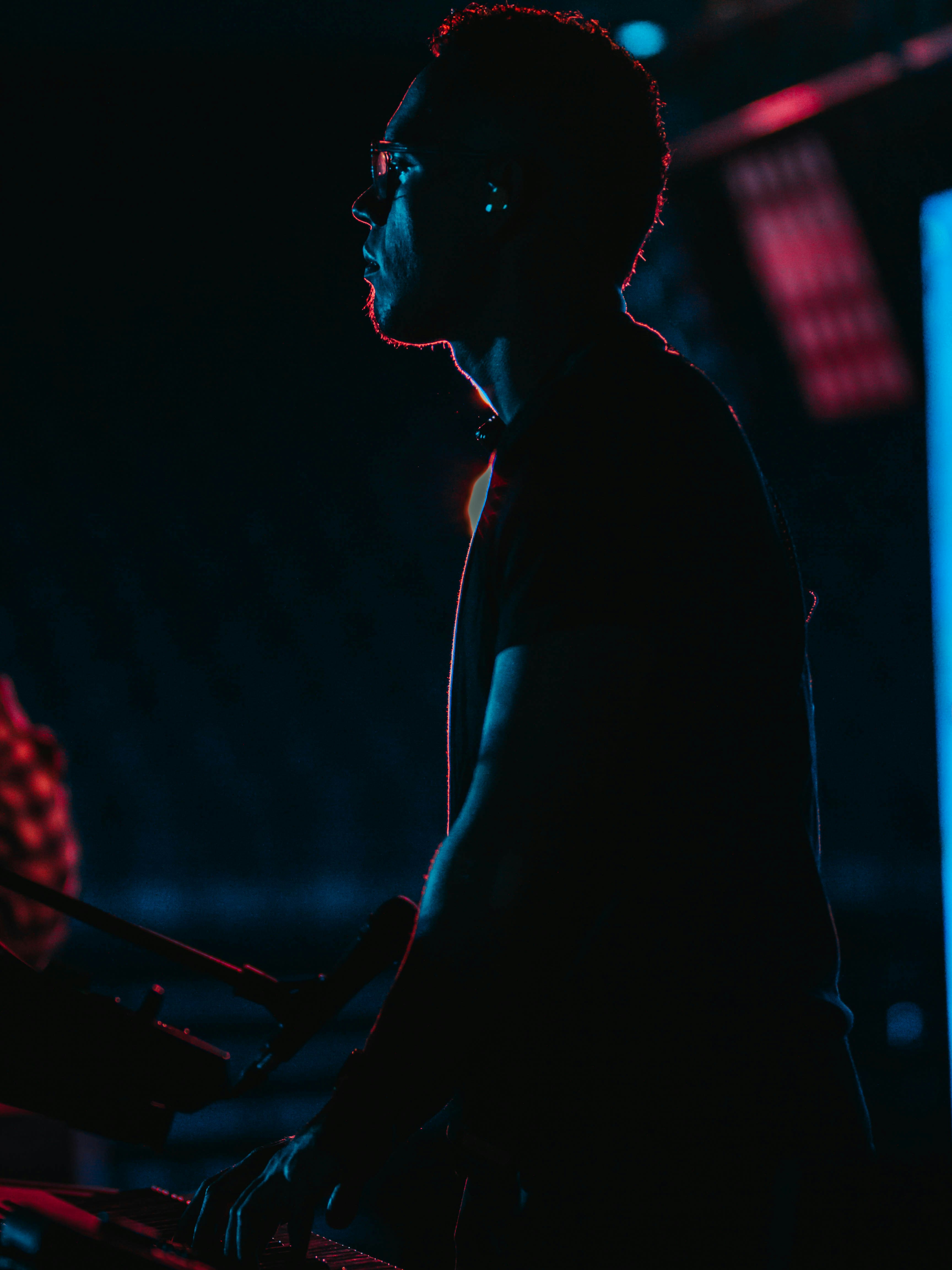 man wearing black T-shirt performing on stage
