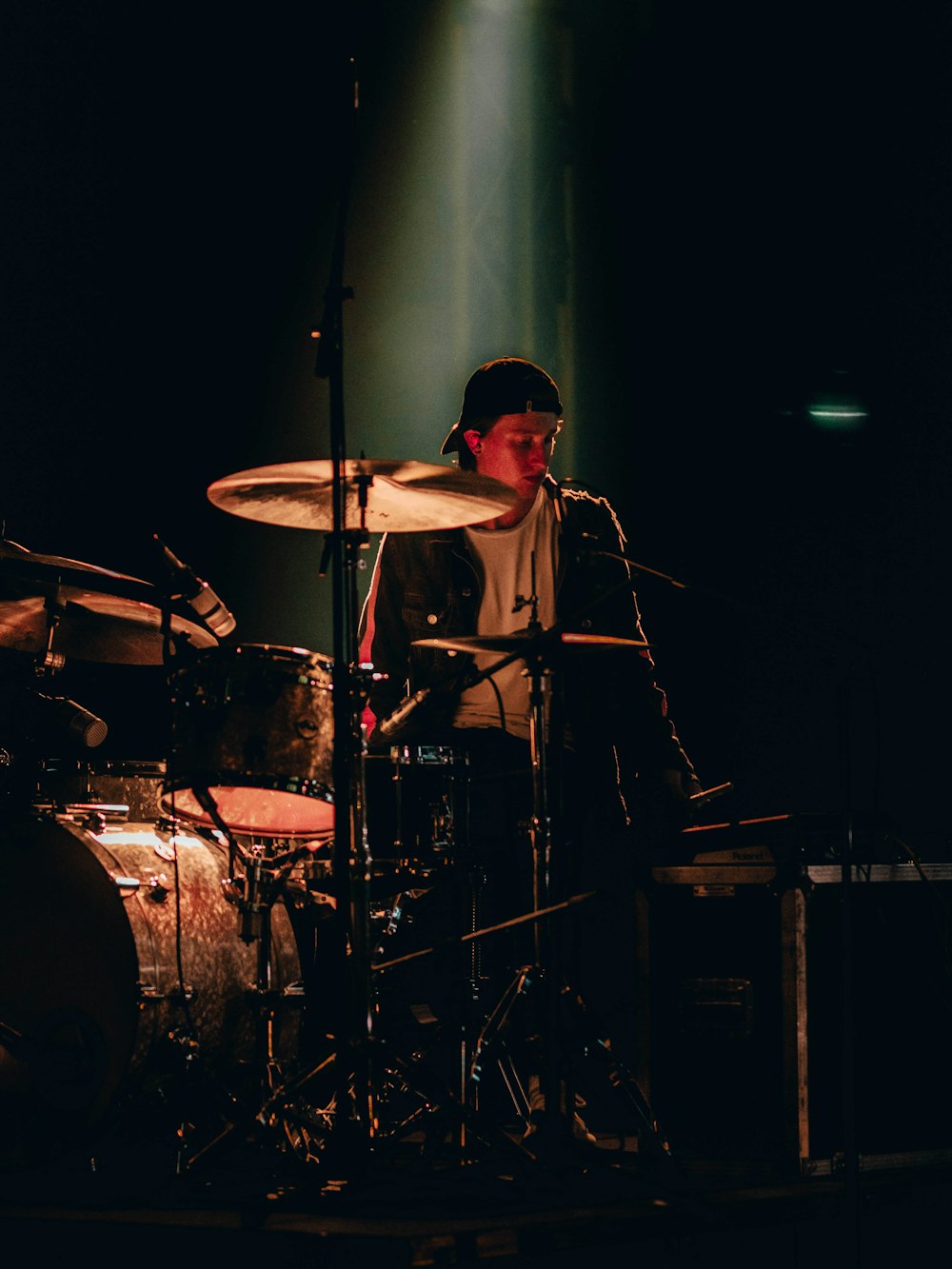 man playing drums on stage
