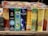 A variety of incense stick boxes are displayed in a row, featuring colorful and diverse designs. Each box has distinct branding and imagery, such as a blue Om design, coconut visuals, and vibrant patterns with gold accents.