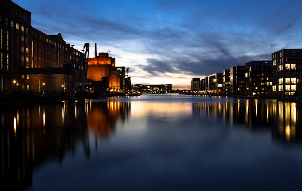 silhouette photo of sea beside building