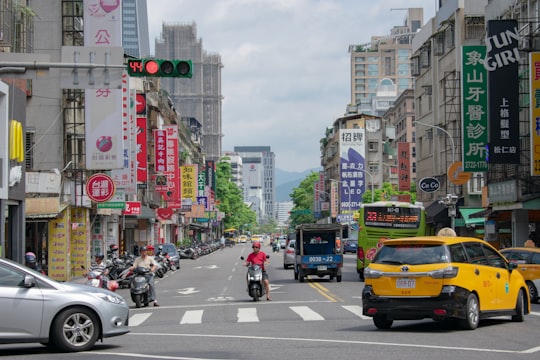 vehicles on road at daytime in Taipei Station Taiwan