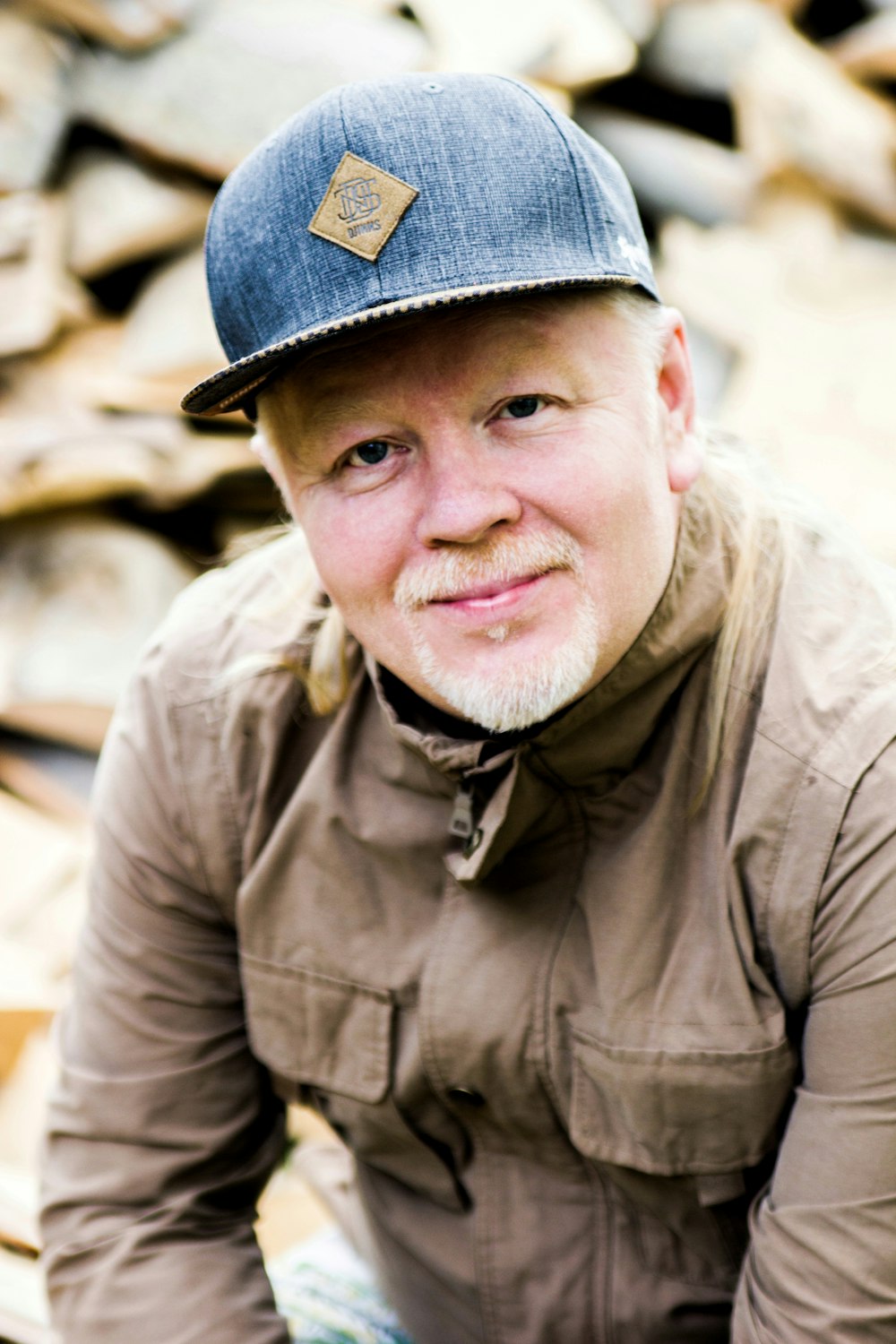 man in brown jacket and gray cap