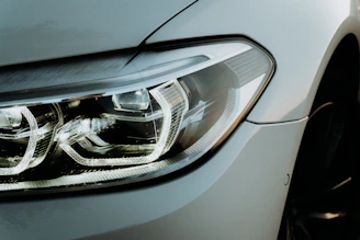 Before-and-after comparison of a restored headlight lens with crystal-clear clarity.