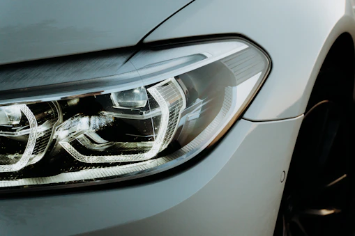 Before-and-after comparison of a restored headlight lens with crystal-clear clarity.