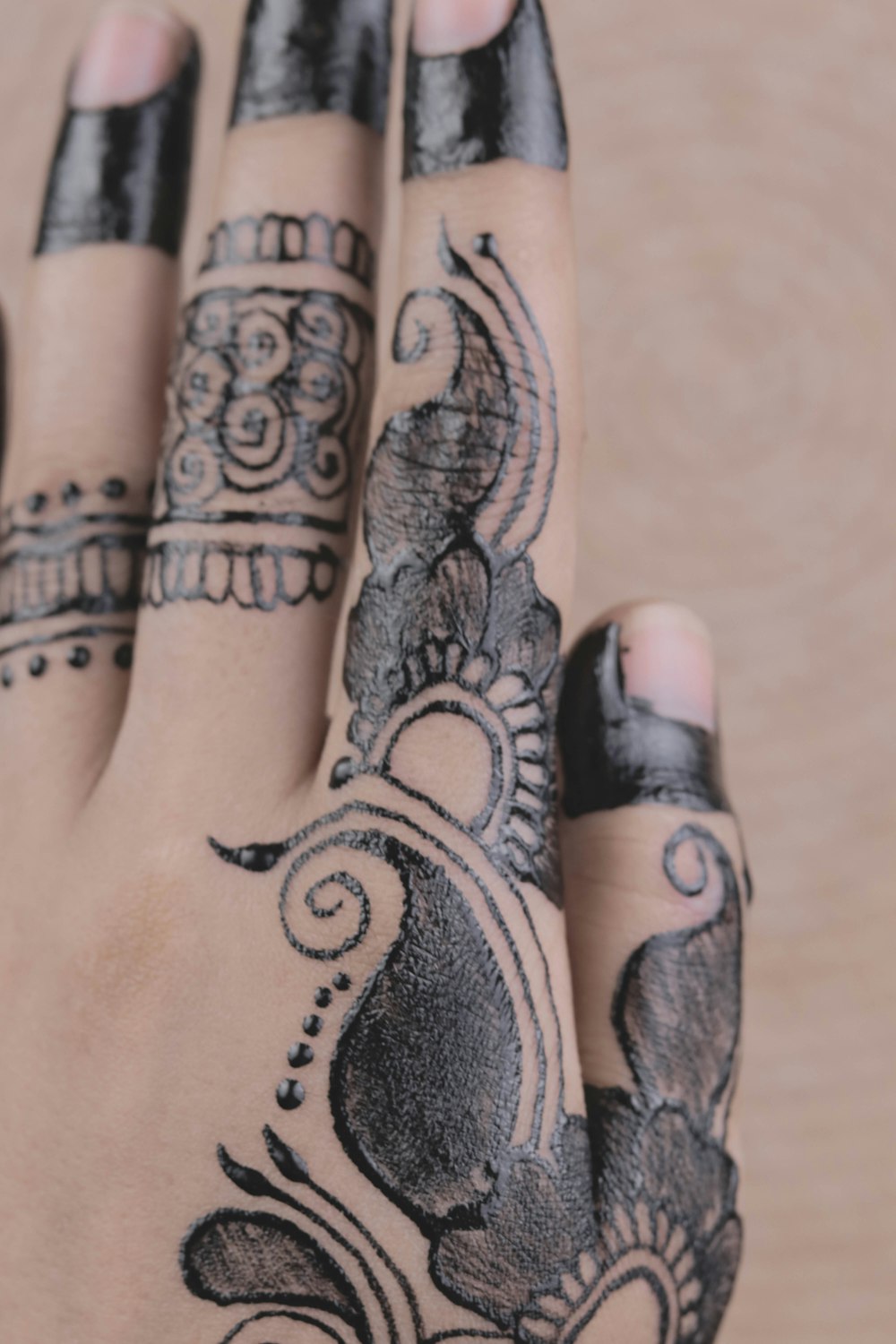 person with mehndi fingers tattoo