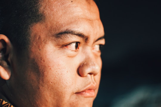 Close-up of a polished portrait with cinematic lighting emphasizing sharp facial features.