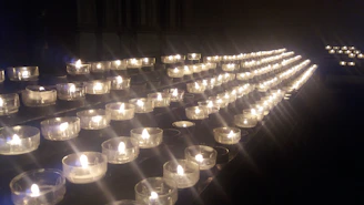 Softly glowing candles and crystals arranged on a warm taupe cloth, evoking calm and focus.